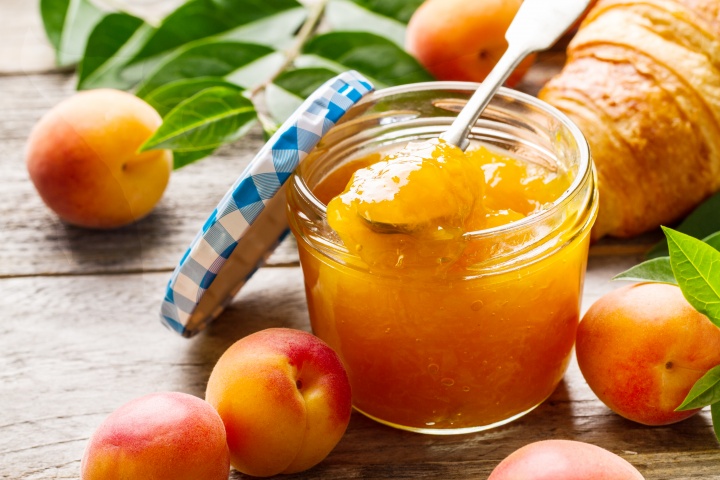 tasty-fruit-orange-apricot-jam-glass-jar-with-fruits-wooden-table-closeup